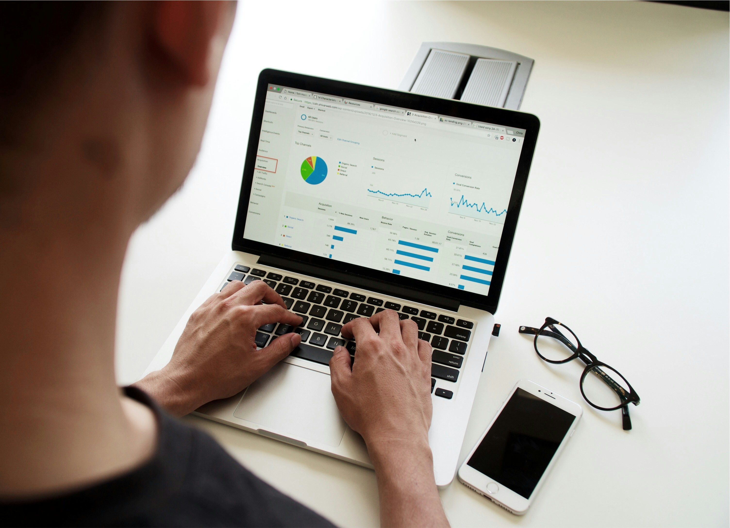 An analyst reviewing charts and performance trends on a laptop